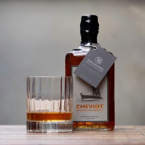 Tar Barrel Cheviot Australian Whiskey bottle pictured beside glass of whiskey