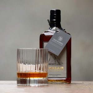 Tar Barrel Corsair Australian Whiskey bottle pictured beside glass of whiskey